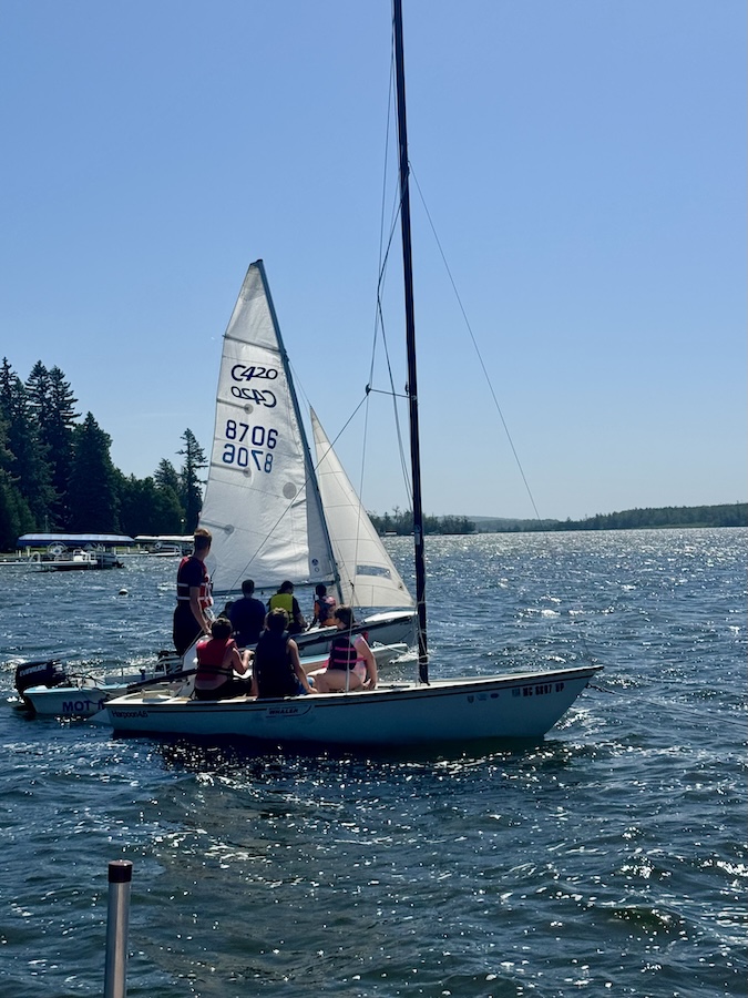 Kids on a small sailboat off the shore of Mackinac Island